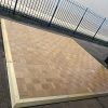 Super-Seat | A Mobile dance floor, wooden floor with brass edge approx. 15m2 | Wooden dance floor with brass edge, golden and light brown, outdoors on concrete. | Mobilier de restauration