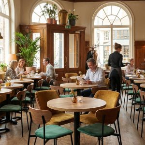 Super-Seat | Vous allez rencontrer des chaises, des tables... | Chaises et tables en bois, tabourets en métal, tables de pique-nique devant des fenêtres pleines de lumière et de plantes. | Mobilier de restauration